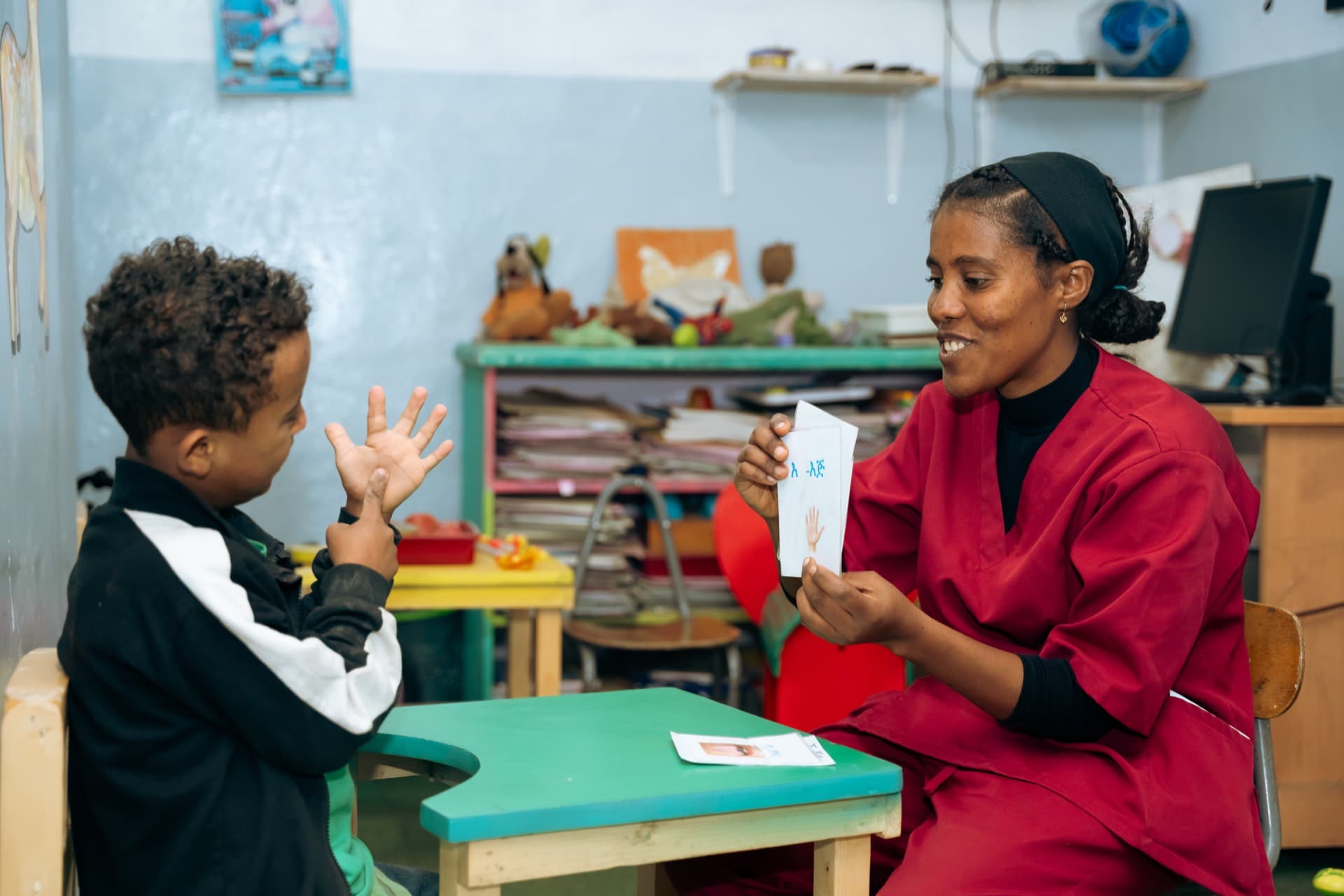 Child learning words with illustrated cards